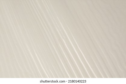 Empty Crumpled Wet Cellophane Paper Blank Texture Copy Space Wave Background. Beige Pastel Color.