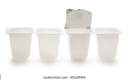 Empty crushed plastic yogurt pots on white