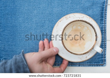 An empty cup of coffee on a wooden table. Hot drink in the morning