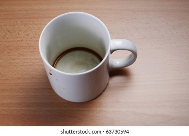 An Empty Cup Of Coffee Viewed From Above On A Wooden Table.