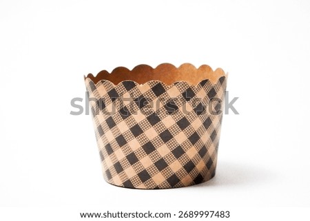 Empty cupcake baking cases pack isolated on white background, top view. Brown greaseproof paper baking cups. Muffin cases, cupcake liners
