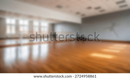 Empty dance studio with ballet barre, large mirrors, and hardwood floors.