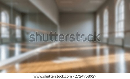 An empty dance studio featuring a barre, large mirrors, natural light and a wooden floor.
