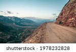 Empty dangerous narrow cliffside  mountain road. Dangerous off road driving along mountain edge and steep cliff. Dagestan.