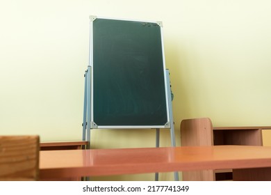 Empty Dark Green Vertical Chalkboard Stands In Empty Classroom. Education Concept.