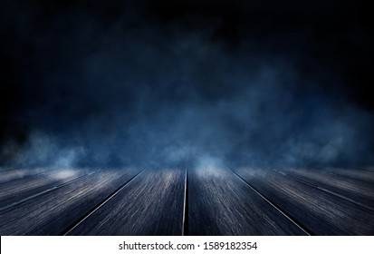 Empty Dark Room, Brick Wall And Concrete Floor. Empty Building Scene. Blue Neon Light. Dark Empty Scene, Blue Neon Searchlight Light, Wet Asphalt, Smoke, Night View, Rays.