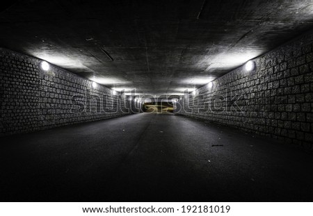 Empty dark tunnel at night