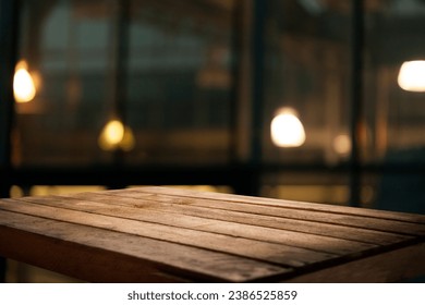 Empty dark wooden table in front of restaurant abstract blurred bokeh background. Can be used to display or mount your products. Mockup for empty space