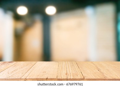 Empty dark wooden table in front of abstract blurred background of restaurant . can be used for display or montage your products.Mock up for display of product - Shutterstock ID 676979761