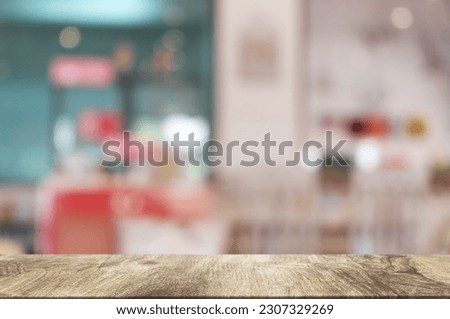 Empty dark wooden table in front of abstract blurred boken bankground of restaurant. Can used for display or montage your products. Mock up for space.