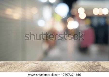 Empty dark wooden table in front of abstract blurred boken bankground of restaurant. Can used for display or montage your products. Mock up for space.