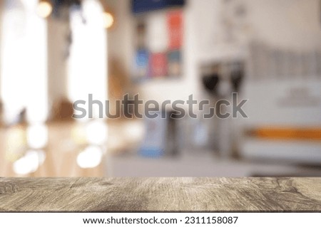 Empty dark wooden table in front of abstract blurred boken bankground of restaurant. Can used for display or montage your products. Mock up for space.