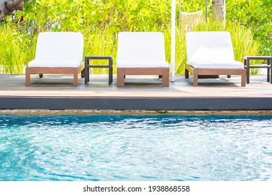 Empty Deck Chair Around Outdoor Swimming Pool In Hotel Resort For Leisure Vacation