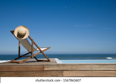 Empty Deck Chair Near Swimming Pool