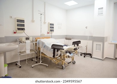 Empty delivery room with bed and medical. space for text. Interior of a hospital ward in maternity clinic. Childbirth. Delivery. Labor concept. Obstetrics and gynecology. Copy advertising space - Powered by Shutterstock