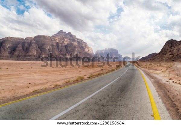Empty Desert Road\
in Wadi Rum Desert,\
Jordan.