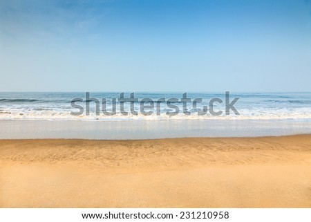 Empty deserted beach with clean blue sky