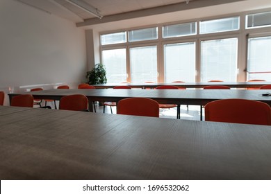 Empty Desks And Chairs In A Cafeteria Room With No People During Corona Virus Pandemic.