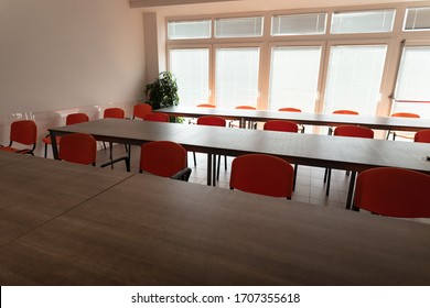 Empty Desks And Chairs In A Cafeteria Room With No People During Corona Virus Pandemic.