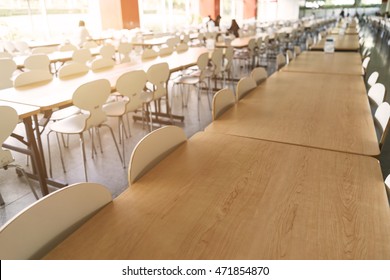 Empty dining table and chair in canteen, cafeteria hall interior 