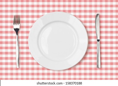 Empty Dinner Plate Top View On Pink Picnic Table Cloth