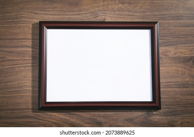 Empty diploma or certificate frame on the table.