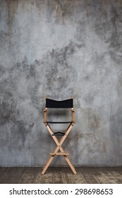 Empty Directors Chair Against Grungy Wall