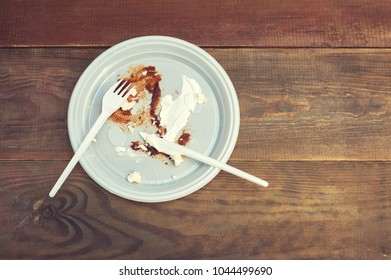 Empty Dirty Plastic Plate After Dinner On Wooden Table