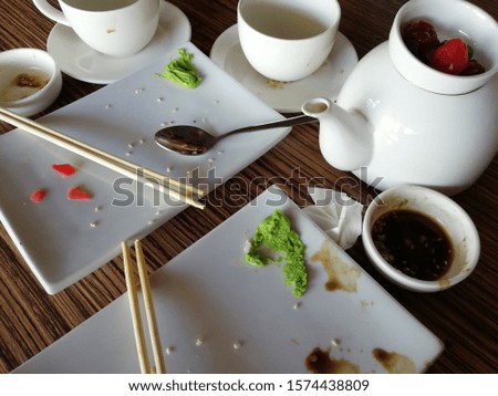 Empty dirty plate of sushi on table in cafe