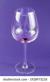 Empty Dirty Wine Glass On A Blue Background. High Stem Red Wine Glass. Selective Focus.