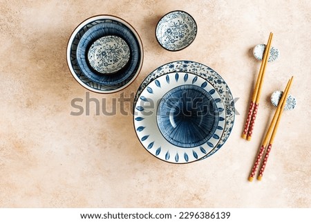 Empty dishes in Asian style with blue ornament, top view.
