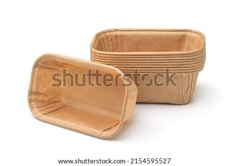 Empty disposable rectangular brown paper baking molds isolated on white