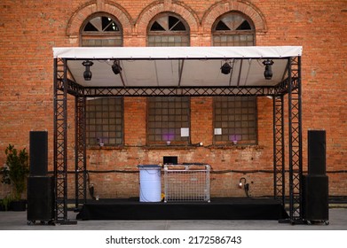 Empty DJ Booth Against A Brick Wall. Party At A Closed Factory