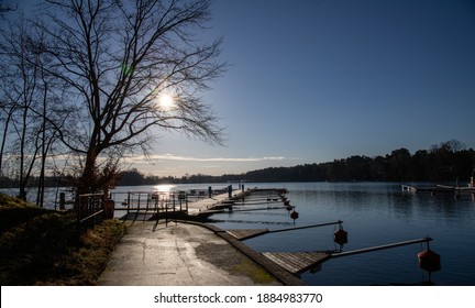 Empty docks in the port of Scharmuetzelsee, Brandenburg, Germany. Empty docks in winter under the clear sky at noon.