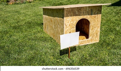 Empty Dog House Outdoors Over Green Grass