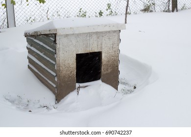 An Empty Dog House In The Winter Is Covered With Snow