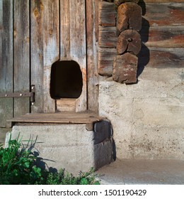 Empty Dog Kennel Made In A Wooden Wall Of Barn