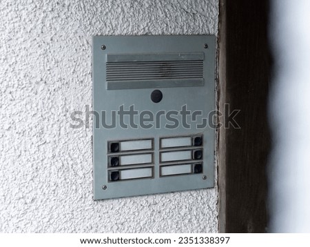 Empty door bell buttons without names. Blank spaces because of residential vacancy. Close up of the bell system with an intercom function.