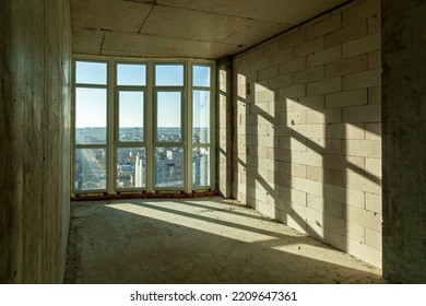 Empty Draft Rooms In A High-rise Building Under Construction. Shadows From Window Frames On The Wall On A Sunny Day