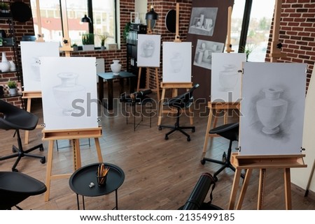 Empty drawing class with nobidy in it prepared for drawing lesson on paintng canvas. No people in creativity workshop equipped with professional tools to develop artistic students skills.