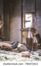 Empty dusted bottles in a ledge at adevastated house