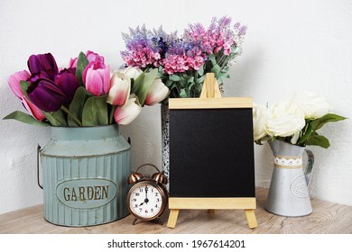 Empty Easel Chalkboard Sign Mockup With Alarm Clock And Flower Decoration