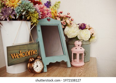 Empty Easel Chalkboard Sign Mockup With Alarm Clock And Flower Decoration