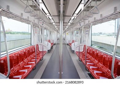 Empty elevated train coach with red seats. Inside of a train carriage - Powered by Shutterstock