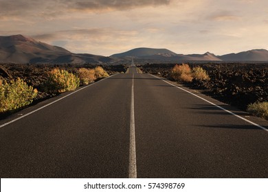 Empty endless highway through the volcanic landscape with copy space