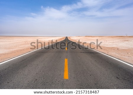 An empty endless road through the desert