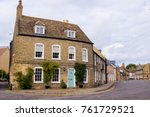 Empty English residential street with row of restored traditional British Victorian houses