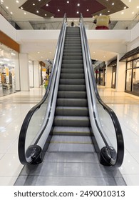 Empty escalator metal steps inside of building