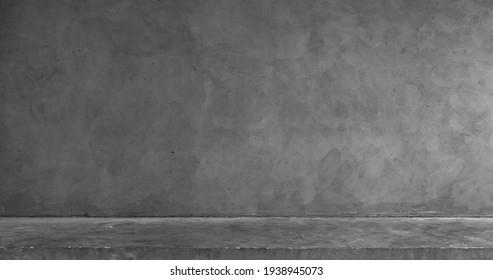 Empty exposed concrete table and wall background, interior backdrop for product display.