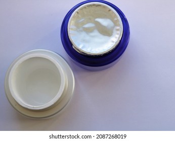 Empty Face Cream Jar And Unopened Jar Top View, Used And New Cream Jars For Skin Care On Light Background, Female Beauty Care Items, Cosmetics Industry Products